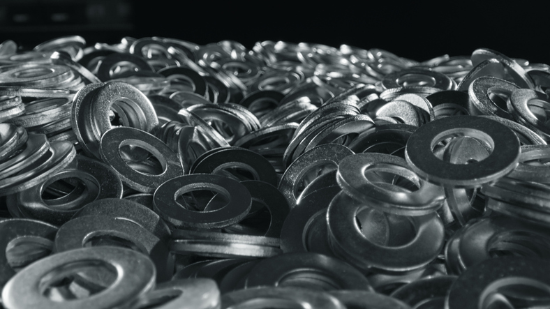 Close-up of stacked aluminum flat washers showing precision machined edges and smooth finish.