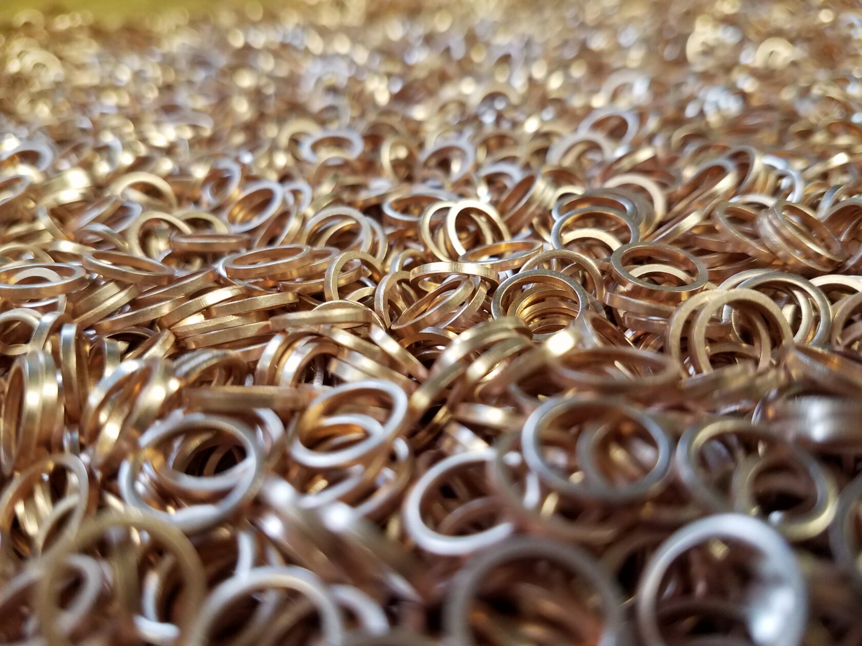 Close-up of hundreds of precision-stamped brass flat washers